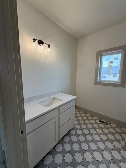 570 El Dorado Ct, Waukee, IA 50263 - bathroom with tile patterned floors, vanity, and baseboards
