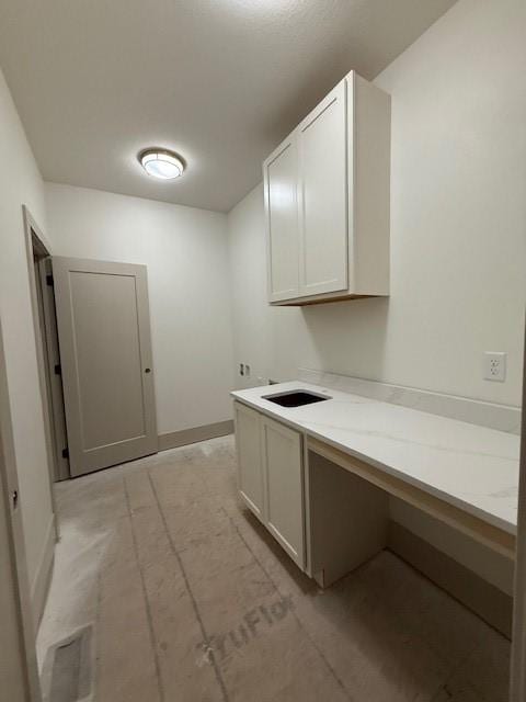 570 El Dorado Ct, Waukee, IA 50263 - laundry room with baseboards and cabinet space