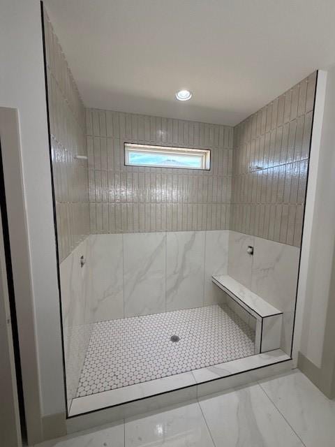 570 El Dorado Ct, Waukee, IA 50263 - bathroom featuring tiled shower, marble look tiles, and recessed lighting