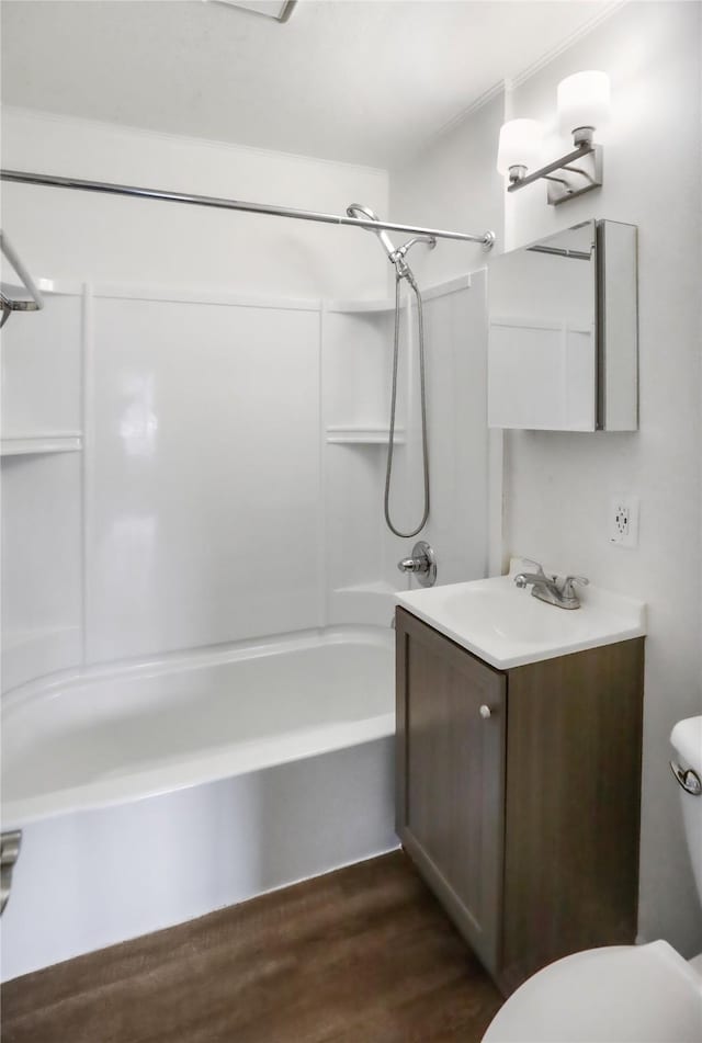 bathroom featuring bathtub / shower combination, vanity, toilet, and wood finished floors