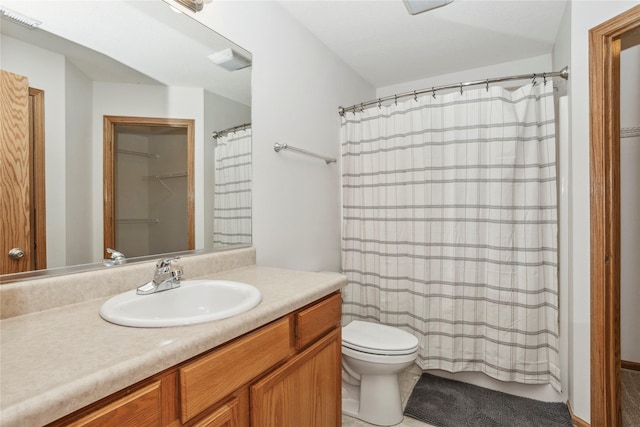 full bathroom featuring toilet, visible vents, and vanity