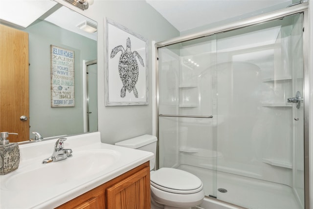 bathroom featuring a stall shower, visible vents, vanity, and toilet