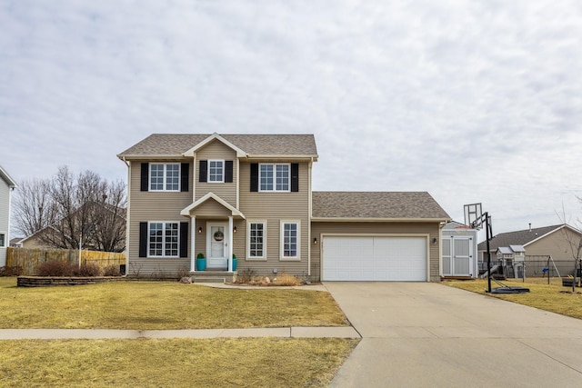 colonial inspired home featuring a shingled roof, concrete driveway, an attached garage, fence, and a front lawn