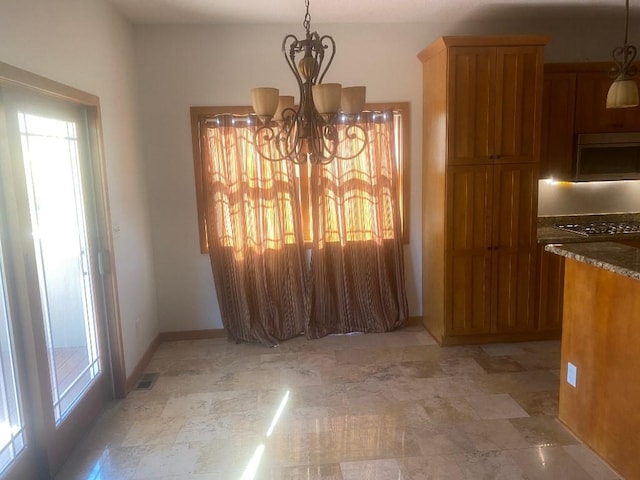 dining room featuring baseboards, visible vents, and a notable chandelier