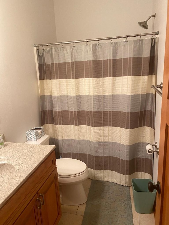 full bath featuring toilet, tile patterned floors, and vanity