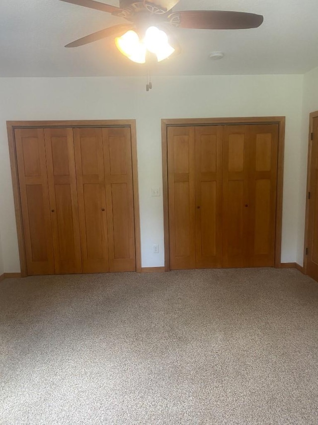 unfurnished bedroom featuring a closet, carpet flooring, ceiling fan, and baseboards