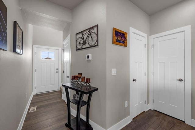 entrance foyer featuring dark wood-style floors, visible vents, and baseboards