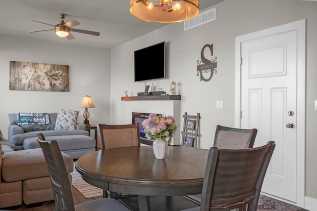 dining space with ceiling fan and visible vents