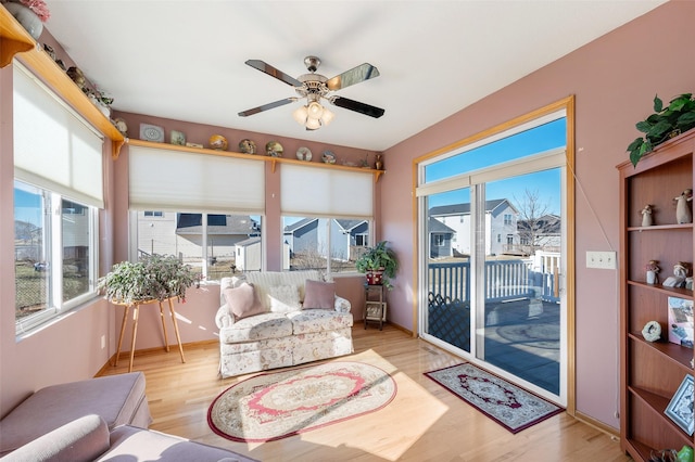 sunroom / solarium with a ceiling fan