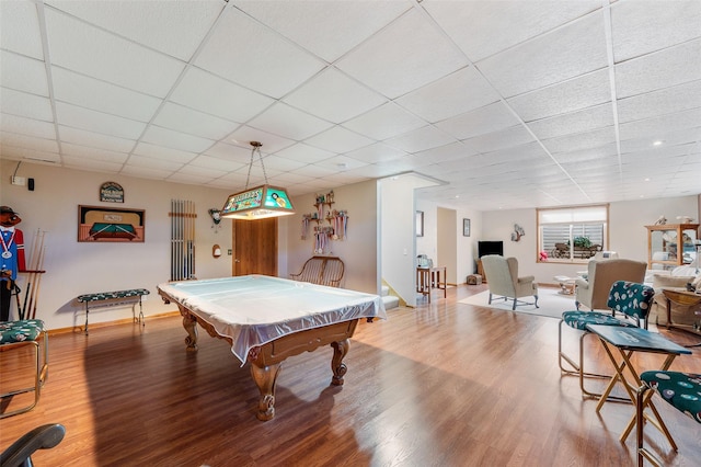 game room featuring a paneled ceiling, pool table, baseboards, and wood finished floors