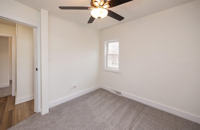 unfurnished bedroom featuring a ceiling fan, carpet flooring, visible vents, and baseboards