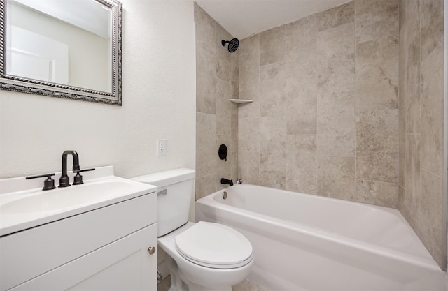 bathroom featuring toilet, a textured wall, tub / shower combination, and vanity