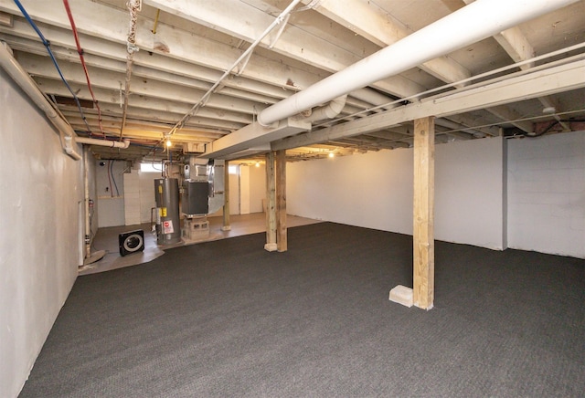 finished basement featuring water heater and heating unit