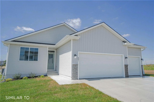 single story home featuring concrete driveway, entry steps, a garage, stone siding, and a front lawn