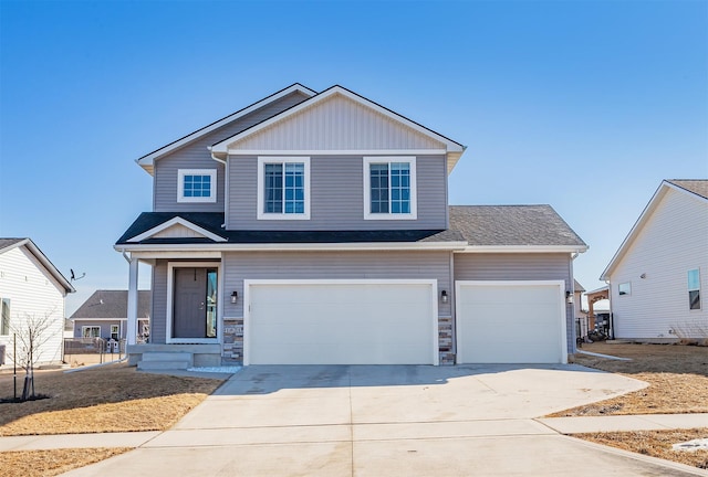 view of front of property with board and batten siding, stone siding, a garage, and concrete driveway