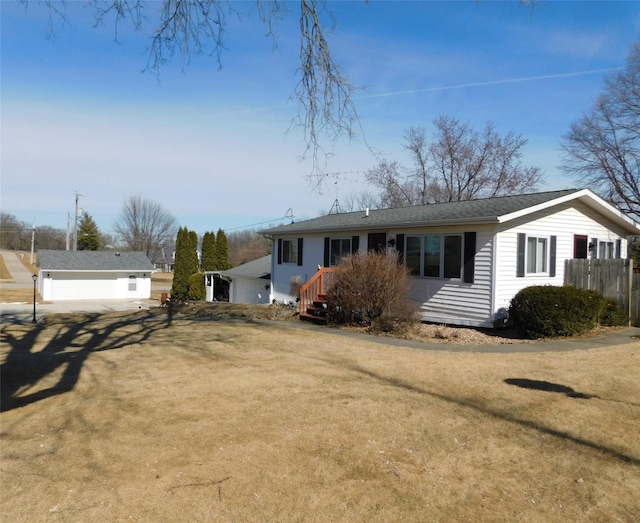 ranch-style house featuring a front yard and driveway