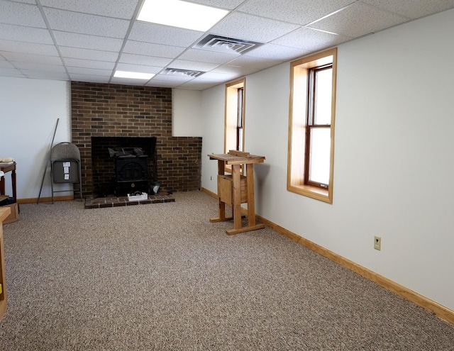 living room featuring carpet flooring, baseboards, visible vents, and a paneled ceiling