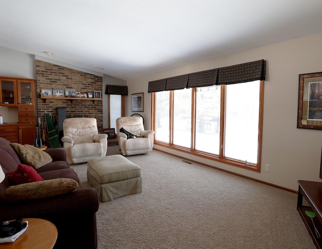 living area with visible vents, baseboards, carpet, and vaulted ceiling