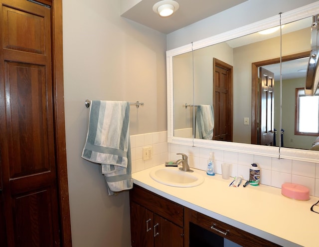 bathroom with tasteful backsplash and vanity