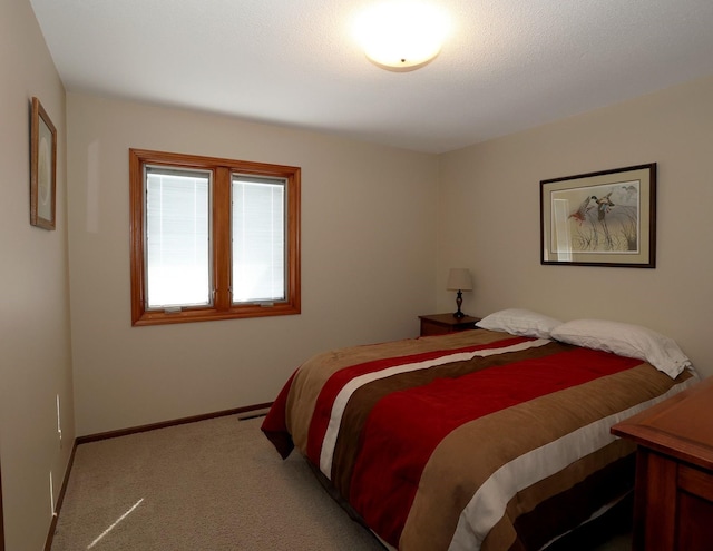 carpeted bedroom with visible vents and baseboards