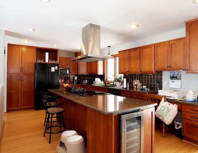 kitchen with a kitchen island, open shelves, black appliances, wine cooler, and island range hood