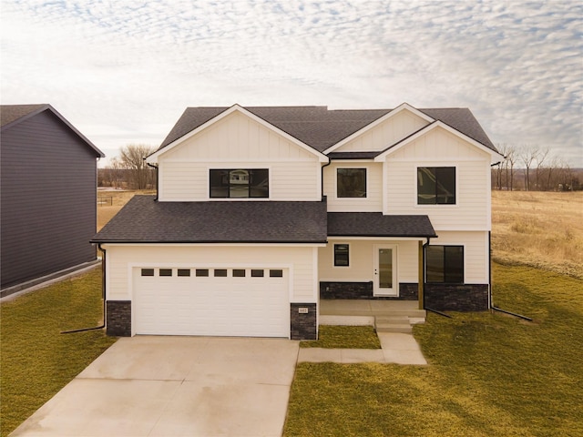 view of front facade with stone siding, concrete driveway, roof with shingles, board and batten siding, and a front yard