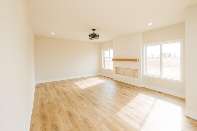 empty room featuring light wood-style flooring, baseboards, and recessed lighting