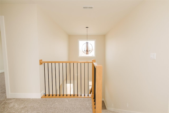 stairs with carpet, visible vents, and baseboards