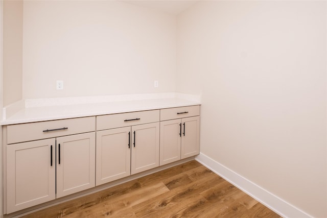 room details with baseboards and wood finished floors