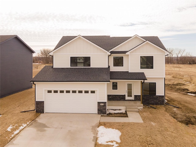 view of front of home featuring stone siding, a shingled roof, board and batten siding, and concrete driveway