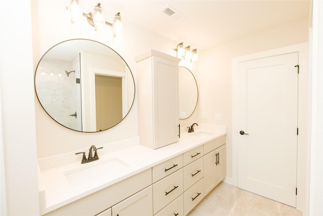 full bath featuring visible vents, a sink, and double vanity