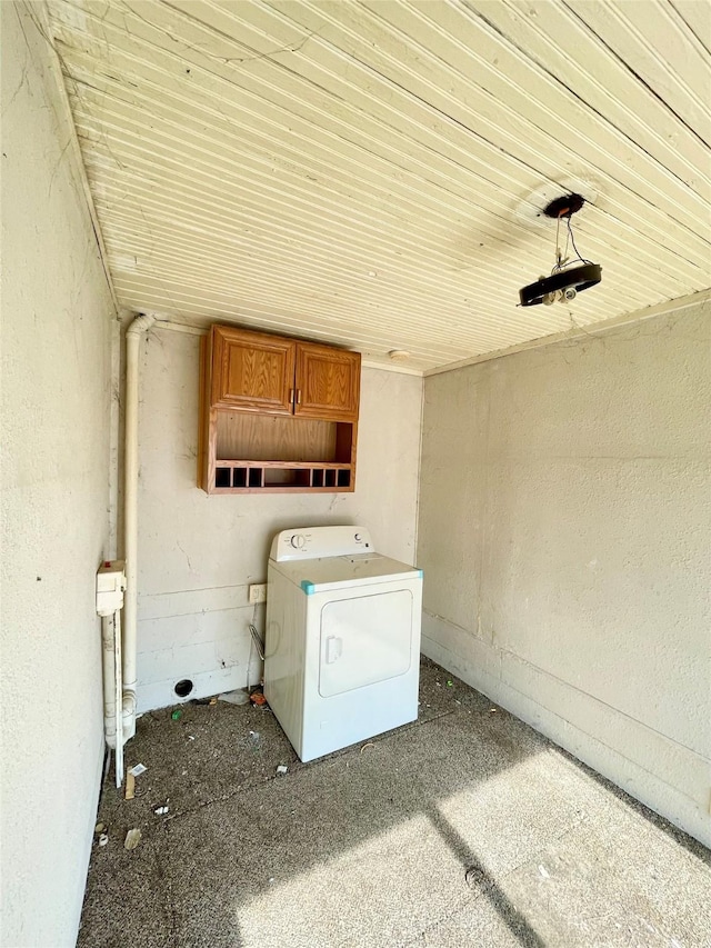 washroom featuring washer / dryer and cabinet space