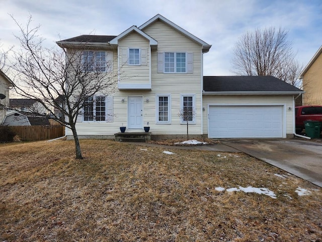 traditional-style house featuring concrete driveway, an attached garage, and fence