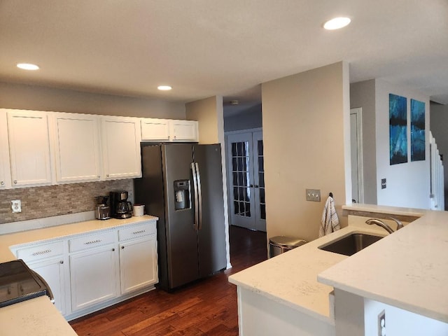 kitchen with dark wood finished floors, white cabinets, stainless steel fridge with ice dispenser, a sink, and recessed lighting