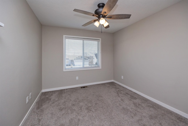 unfurnished room featuring light carpet, ceiling fan, visible vents, and baseboards