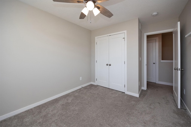 unfurnished bedroom featuring ceiling fan, baseboards, a closet, and light colored carpet