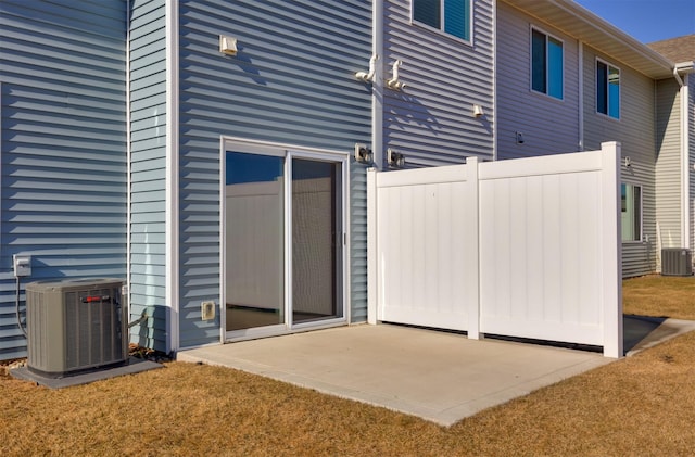 exterior space featuring fence and central AC unit