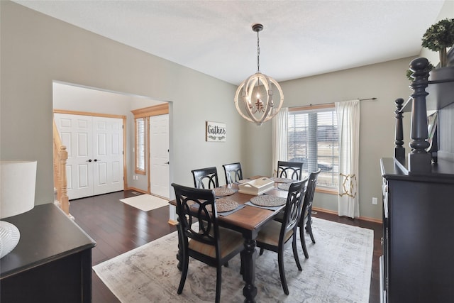 dining space with a chandelier, dark wood-style flooring, and baseboards