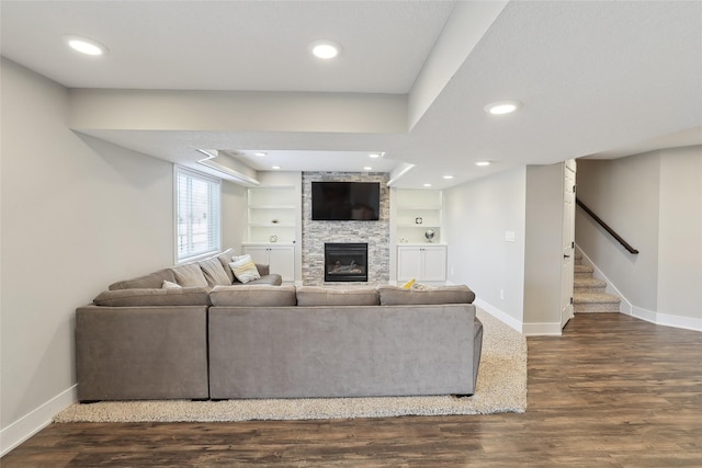 living room featuring stairway, baseboards, and dark wood-style flooring