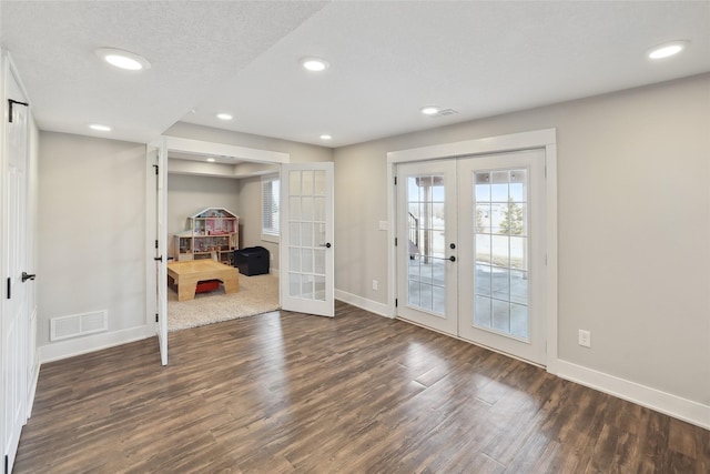 doorway to outside with french doors, visible vents, dark wood finished floors, and baseboards