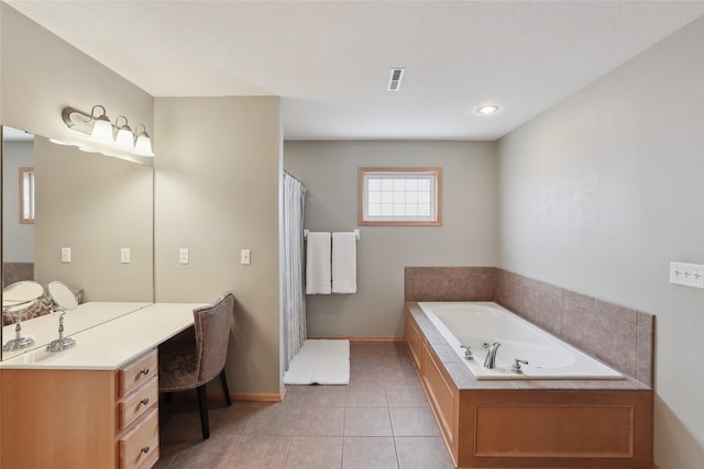 bathroom featuring tile patterned flooring, a garden tub, visible vents, and baseboards