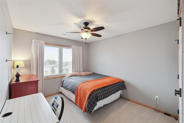 bedroom featuring light carpet, visible vents, baseboards, and a ceiling fan