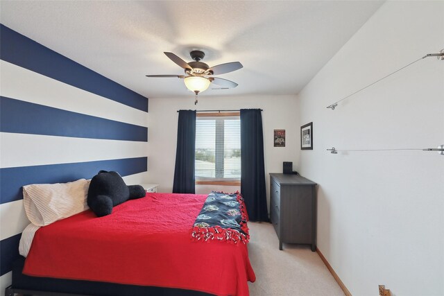 bedroom featuring light carpet, ceiling fan, and baseboards