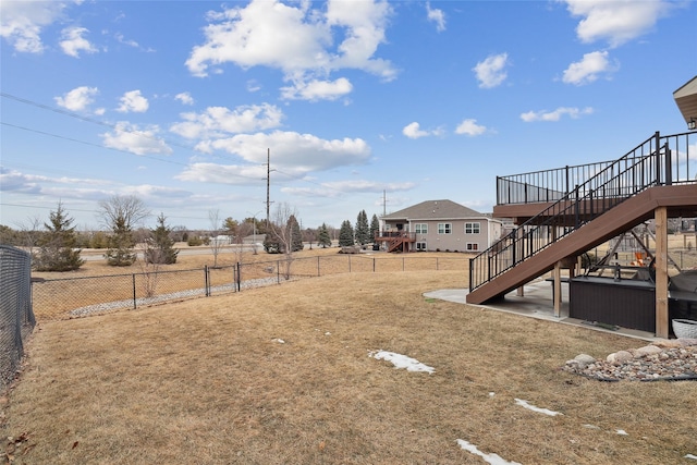 view of yard featuring a fenced backyard and stairs