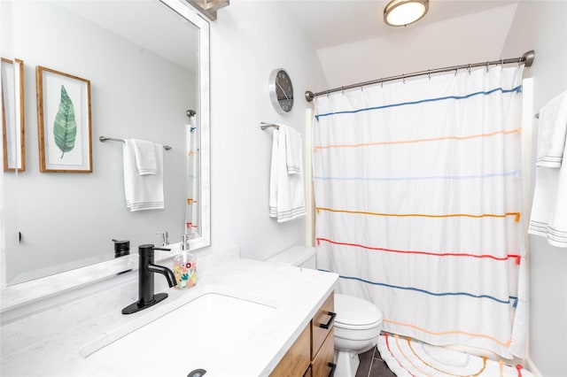 bathroom featuring toilet, a shower with curtain, and vanity