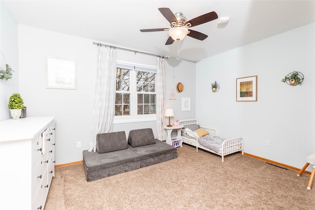 sitting room with light carpet, ceiling fan, and baseboards