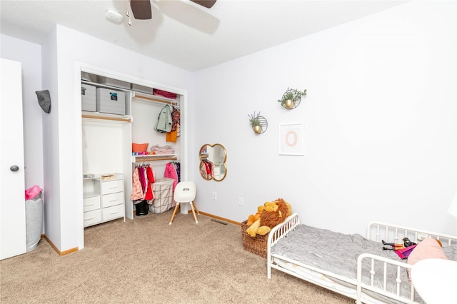 bedroom featuring carpet floors, a closet, baseboards, and a ceiling fan