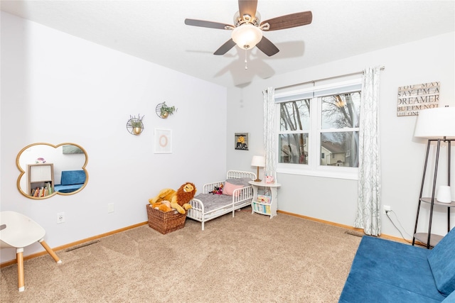 interior space with carpet, baseboards, and ceiling fan