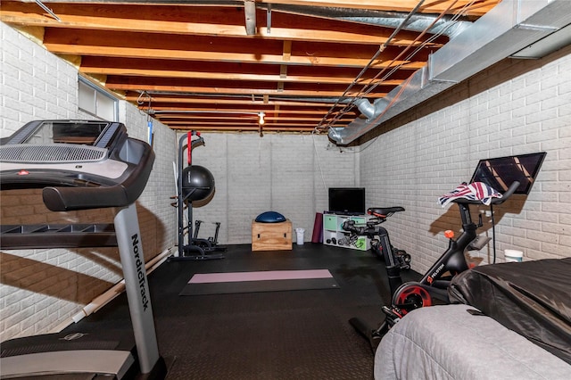 exercise area featuring brick wall