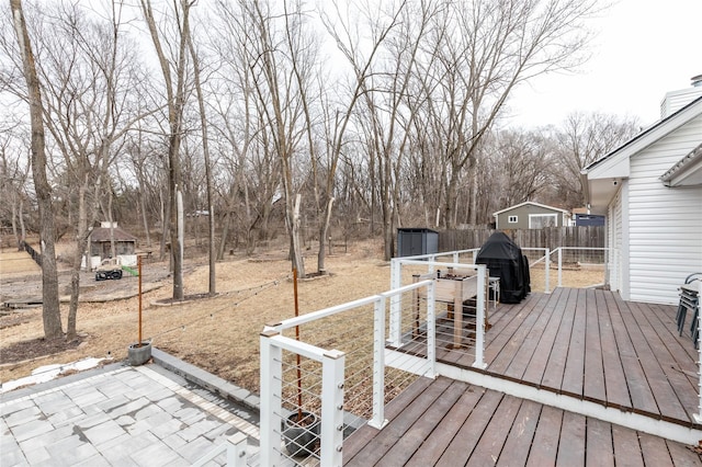 wooden deck featuring area for grilling and fence